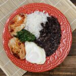 A plate of food with rice and beans for lunch.